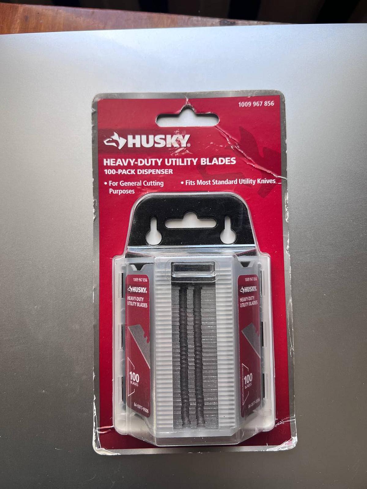 Набор сталевих універсальних лез Husky (100 шт.) у диспенсері.